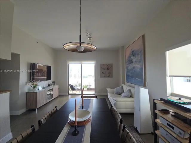 a view of a dining room with furniture window and outside view