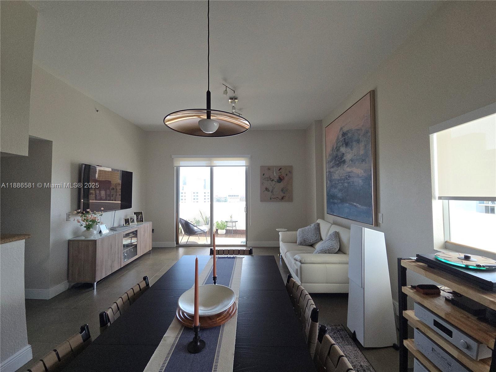 36 Northwest 6th Avenue, Unit TS9 Miami, FL 33128 - Photo 21 of 50 a view of a dining room with furniture window and wooden floor