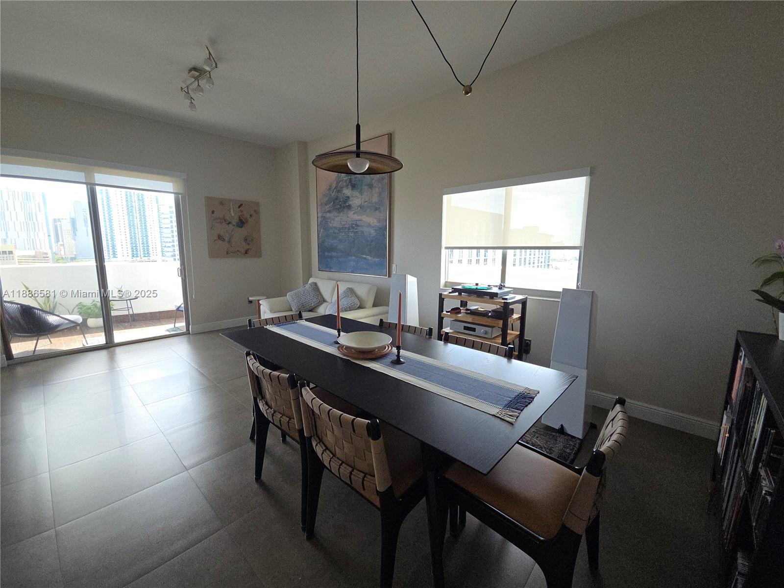 36 Northwest 6th Avenue, Unit TS9 Miami, FL 33128 - Photo 22 of 50 a view of a dining room with furniture window and outside view