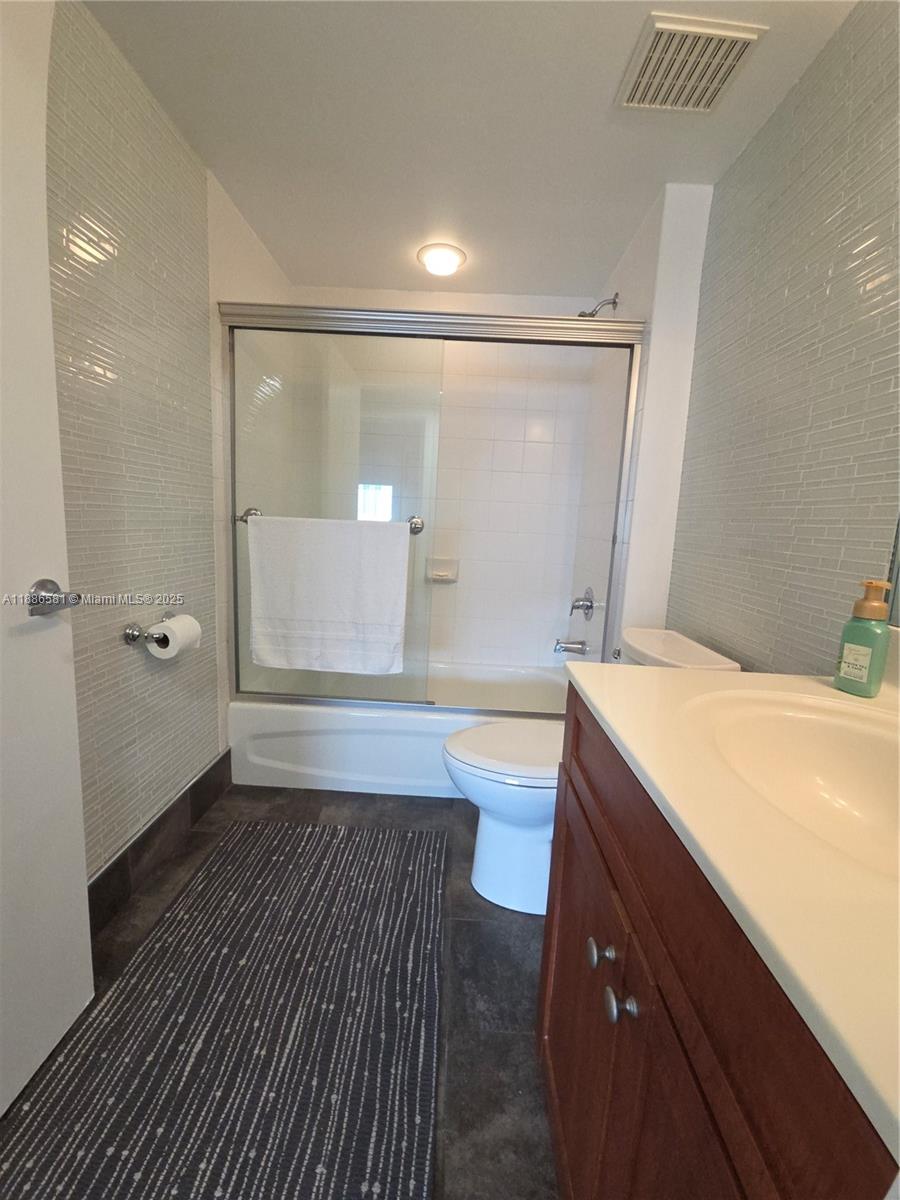 36 Northwest 6th Avenue, Unit TS9 Miami, FL 33128 - Photo 26 of 50 a bathroom with a sink a toilet a mirror and bathtub