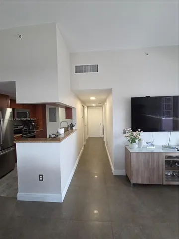 a view of hallway with closet and wooden floor