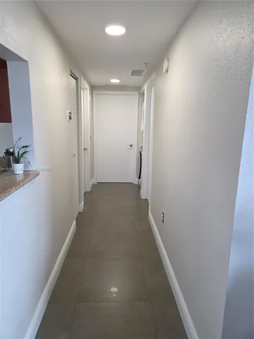 a view of a hallway with washer and dryer
