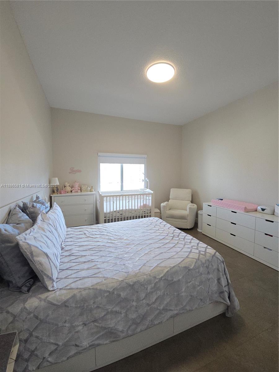 36 Northwest 6th Avenue, Unit TS9 Miami, FL 33128 - Photo 30 of 50 a bedroom with a bed and window
