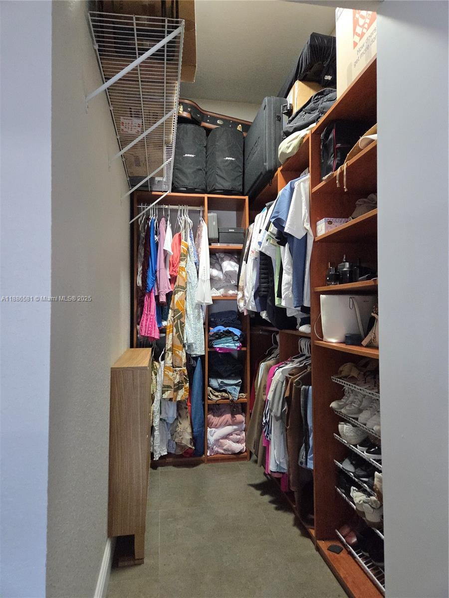 36 Northwest 6th Avenue, Unit TS9 Miami, FL 33128 - Photo 31 of 50 a view of walk in closet with clothes and shoes
