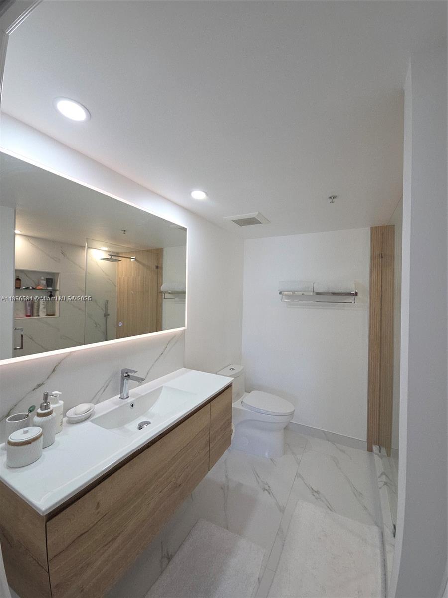 36 Northwest 6th Avenue, Unit TS9 Miami, FL 33128 - Photo 35 of 50 a bathroom with a sink toilet and a mirror