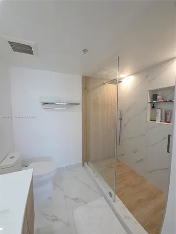 a en suite bathroom with a sink a toilet and shower