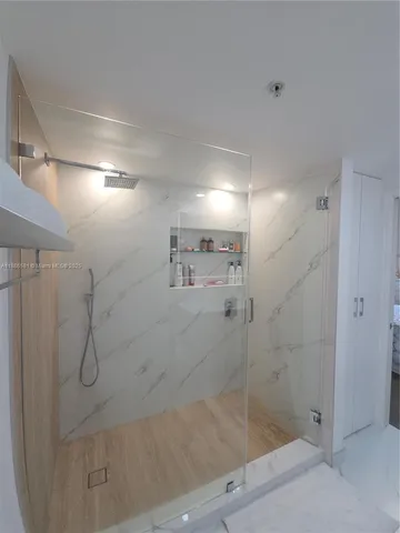 a bathroom with a tub sink and mirror