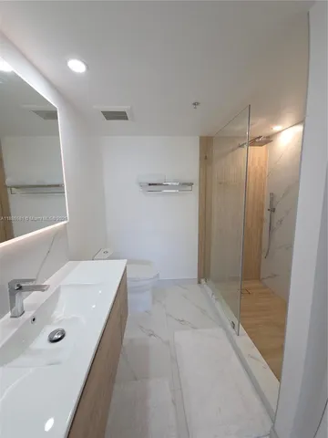 a bedroom with a bed and a night stand