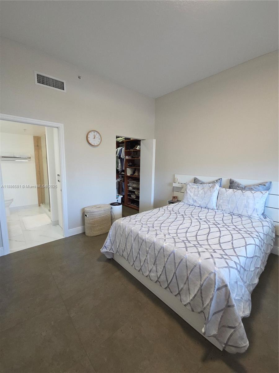 36 Northwest 6th Avenue, Unit TS9 Miami, FL 33128 - Photo 41 of 50 a bedroom with a bed and a night stand