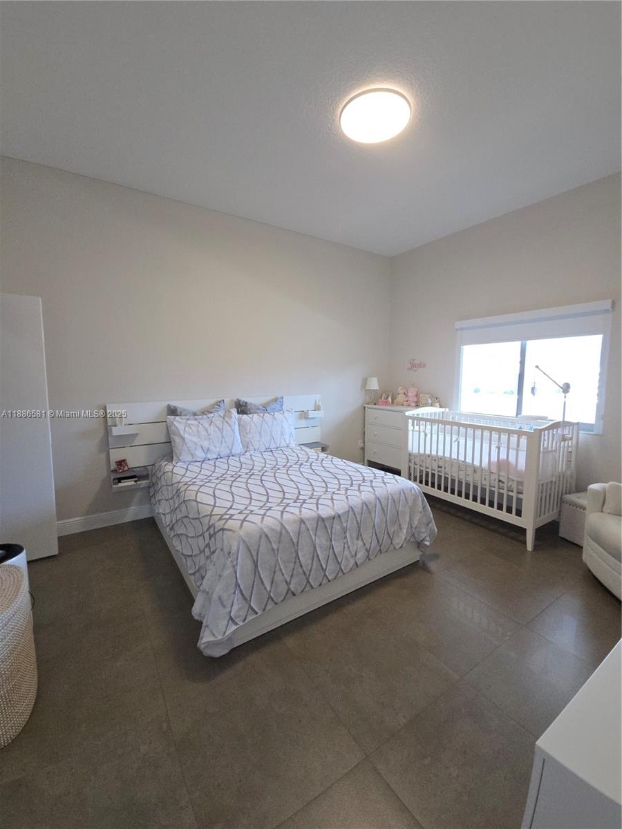 36 Northwest 6th Avenue, Unit TS9 Miami, FL 33128 - Photo 45 of 50 a bedroom with bed and a window