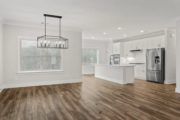 a view of kitchen and kitchen with wooden floor