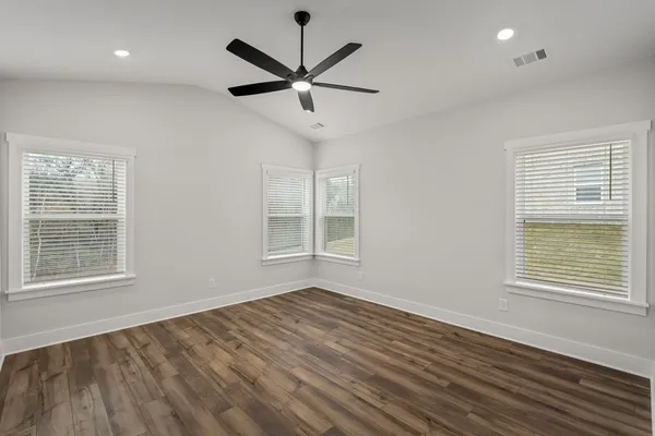 wooden floor in an empty room with a window