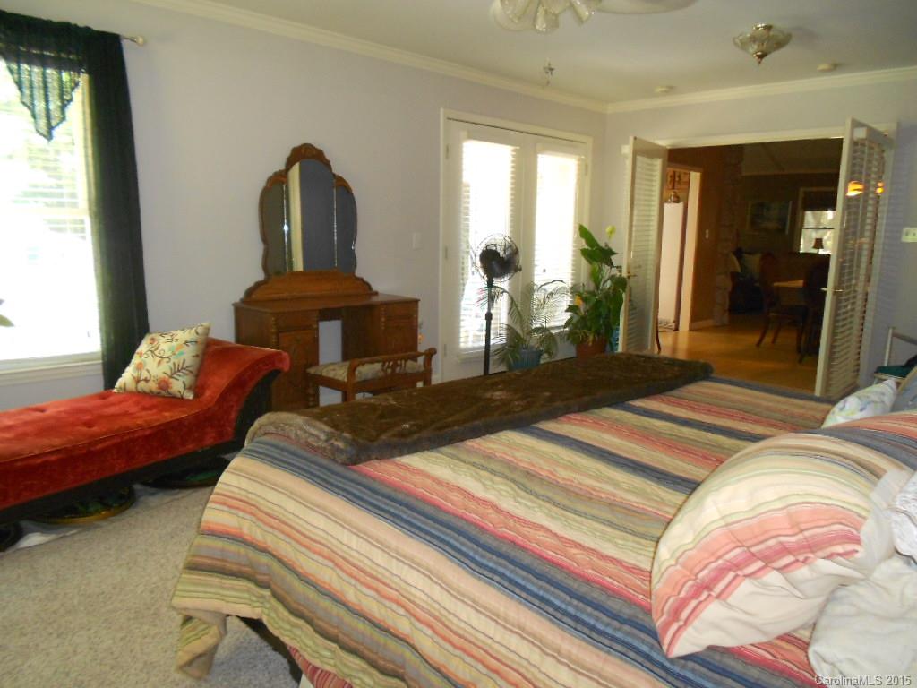383 East Rebound Road Lancaster, SC 29720 - Photo 8 of 22 a bedroom with a bed and large windows