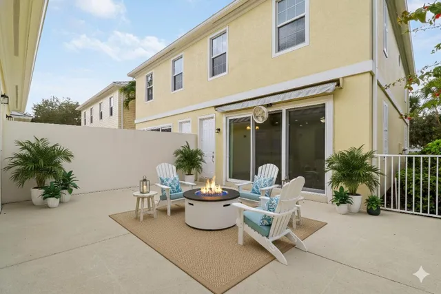 a view of a patio with table and chairs and potted plants