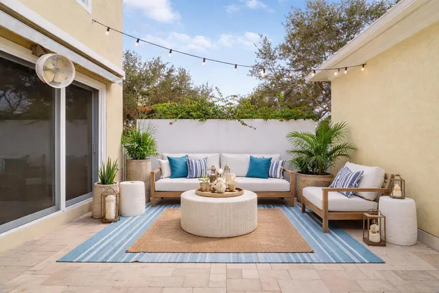 a view of a patio with couches and a potted plant