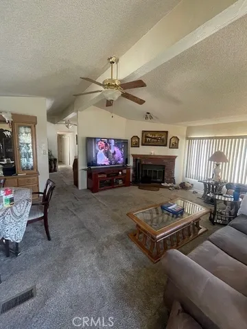 an empty room with a fireplace and fan
