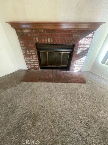 a view of a big room with windows and chandelier