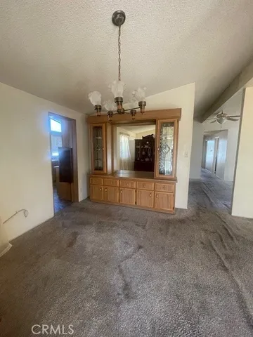a kitchen with refrigerator and cabinets