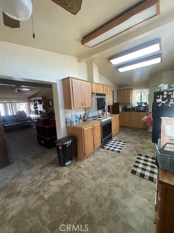 an empty room with windows and ceiling fan