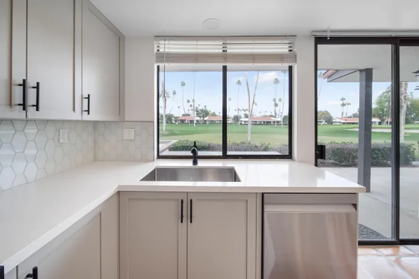 a kitchen with sink and window