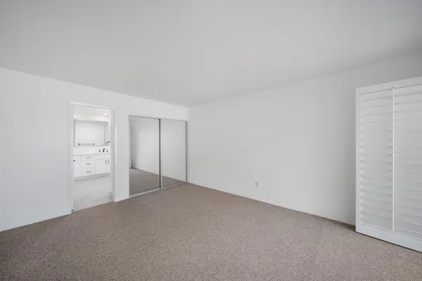 an empty room with closet area