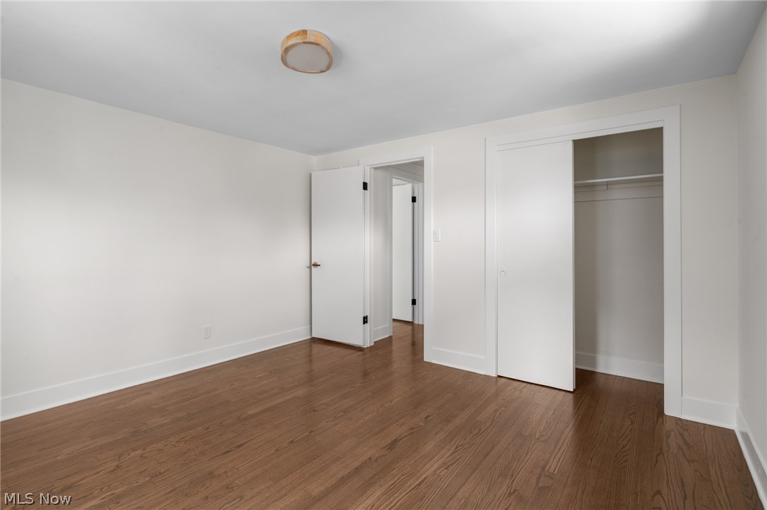 22625 Rye Road Shaker Heights, OH 44122 - Photo 24 of 38 Room featuring wood-finish flooring, white walls, and a modern flush-mount ceiling light