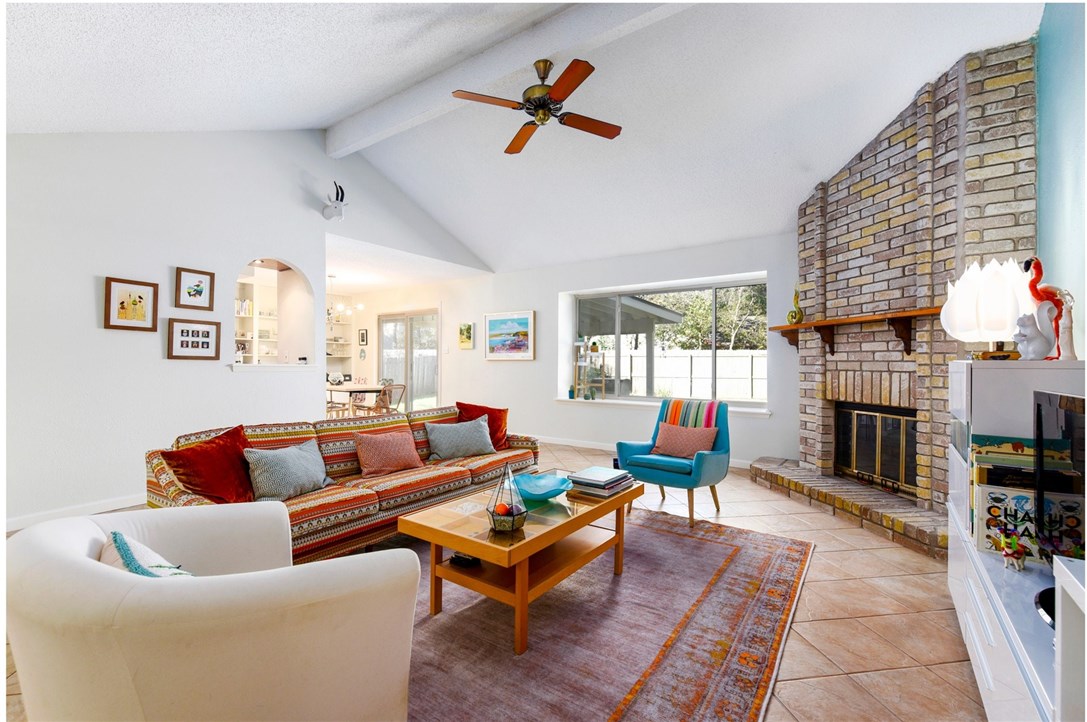 a living room with furniture kitchen view and a fireplace