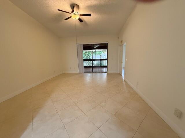 9256 Sable Ridge Circle, Unit D Boca Raton, FL 33428 - Photo 12 of 16 an empty room with windows and ceiling fan view