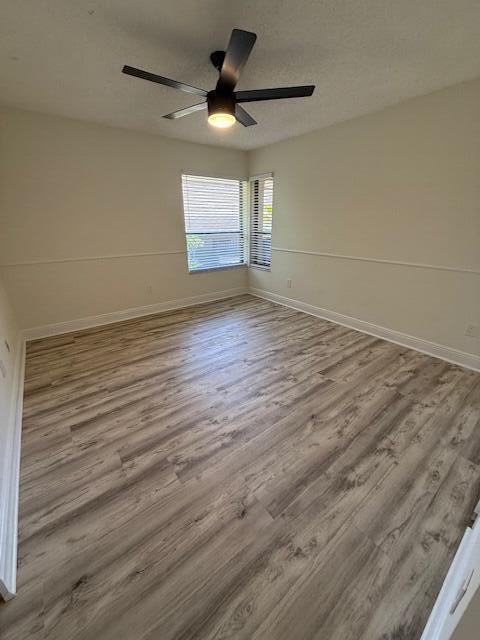 9256 Sable Ridge Circle, Unit D Boca Raton, FL 33428 - Photo 8 of 16 an empty room with wooden floor and windows