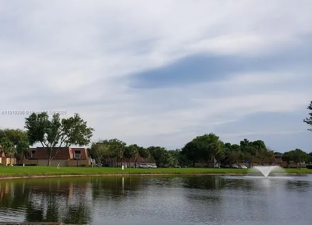 a view of a lake with houses in the back