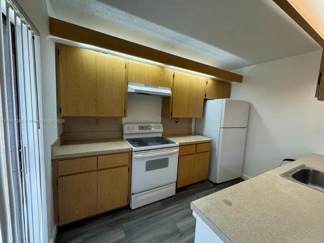 a kitchen with a stove and a refrigerator