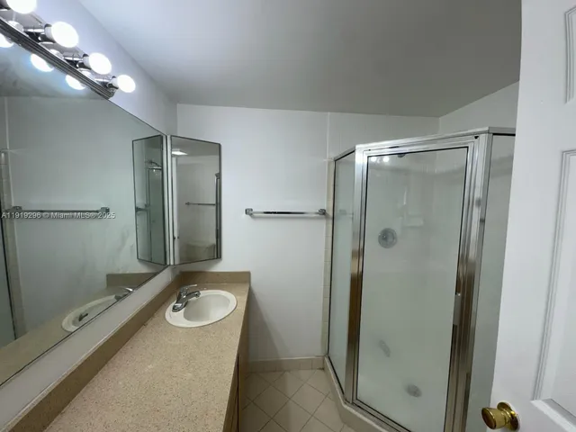 a bathroom with a sink and shower