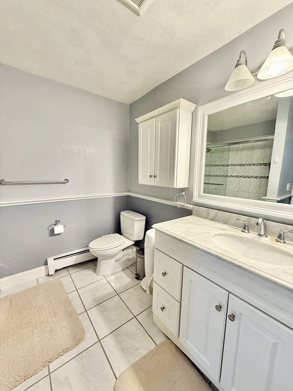 25 Homeward Lane, Unit 25 Natick, MA 01760 - Photo 11 of 16 a bathroom with a granite countertop sink mirror vanity and toilet
