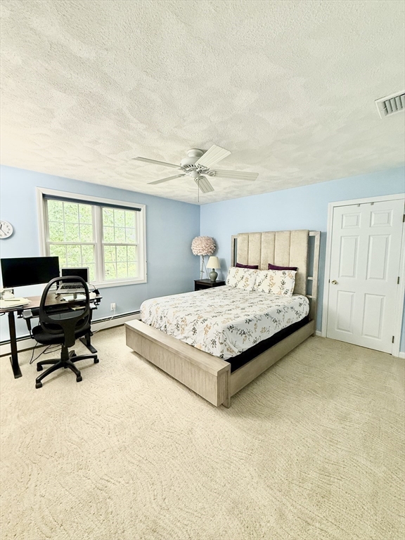 25 Homeward Lane, Unit 25 Natick, MA 01760 - Photo 12 of 16 a bedroom with a bed and a table in it