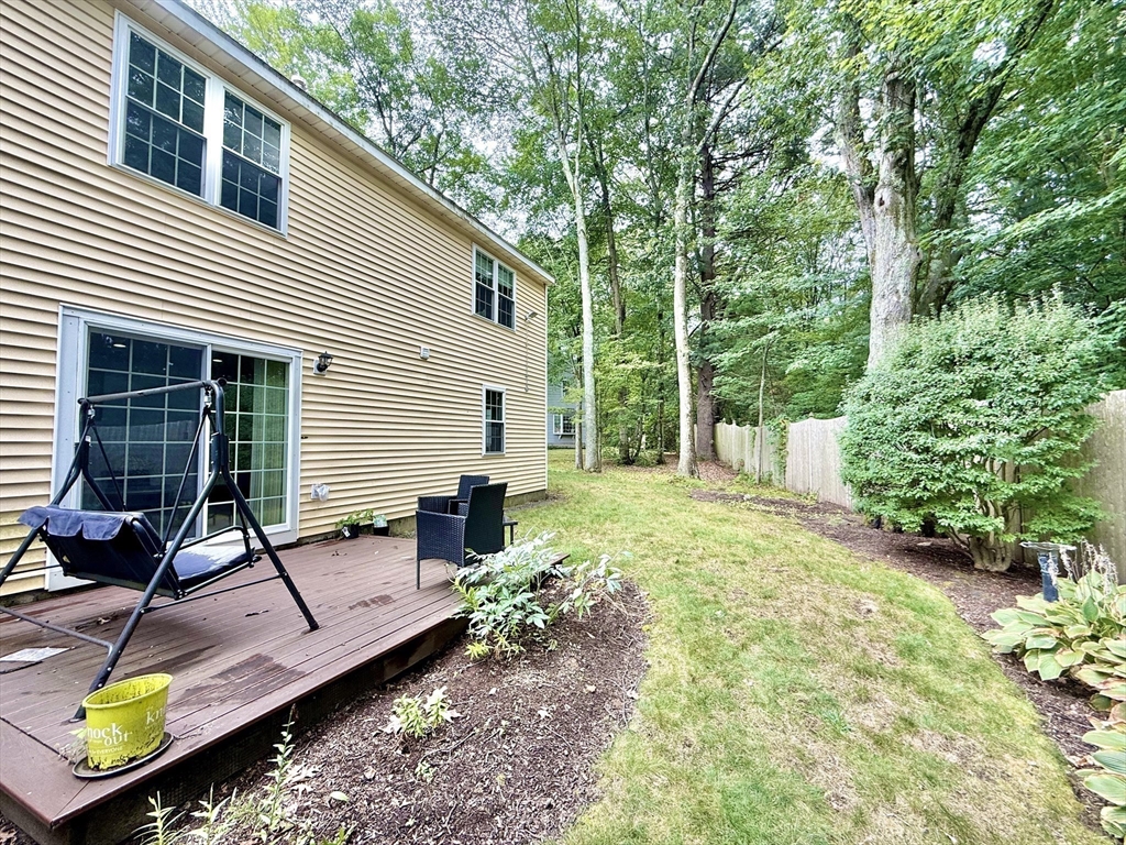 25 Homeward Lane, Unit 25 Natick, MA 01760 - Photo 15 of 16 a view of backyard with a table and chairs and potted plants