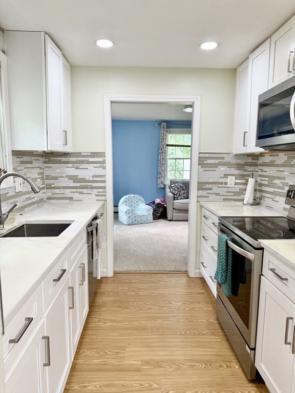 25 Homeward Lane, Unit 25 Natick, MA 01760 - Photo 6 of 16 a kitchen with a sink stove top oven and refrigerator