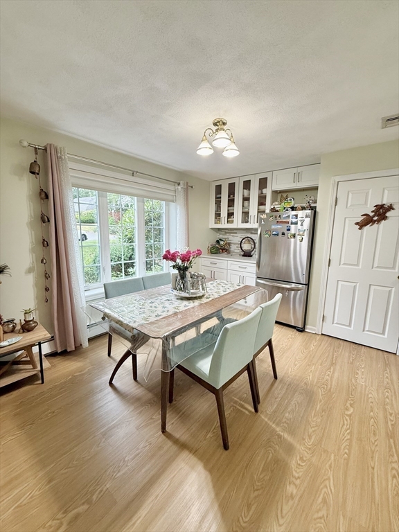 25 Homeward Lane, Unit 25 Natick, MA 01760 - Photo 7 of 16 a living room with furniture a table and wooden floor