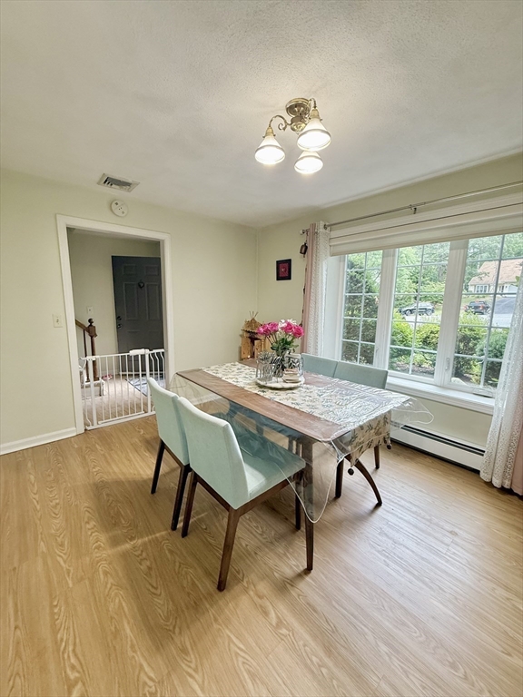 25 Homeward Lane, Unit 25 Natick, MA 01760 - Photo 8 of 16 a dining room with furniture and wooden floor