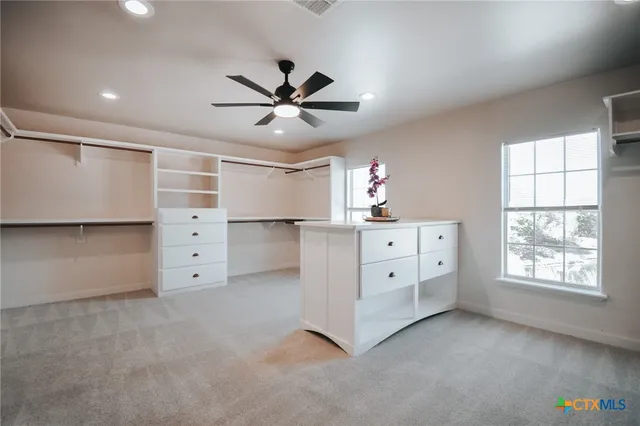 a view of a patio with couches chairs and wooden floor