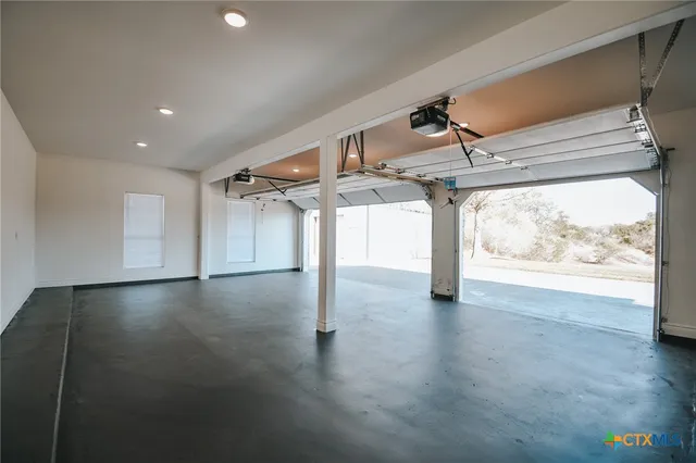 a view of a house with a small yard and large tree