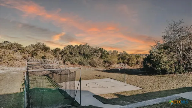 a view of a house with cars park