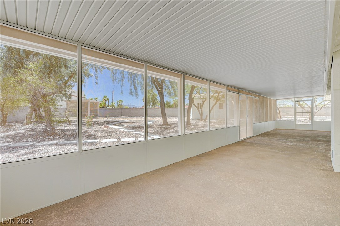 7631 Bermuda Road Las Vegas, NV 89123 - Photo 31 of 64 A spacious screened-in porch offers tranquil views of the private yard, perfect for outdoor enjoyment.