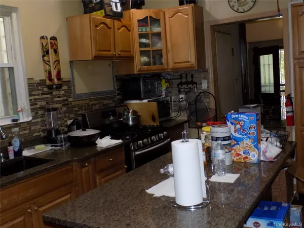 a kitchen with a stove a sink and a dining table with chairs