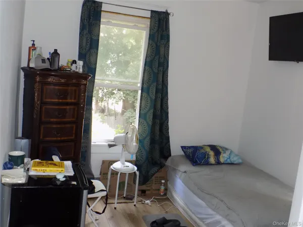 a bedroom with a bed and windows