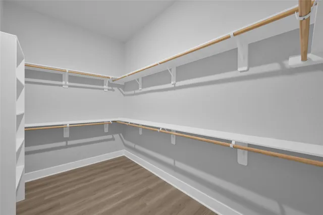 a spacious bathroom with a double vanity sink mirror and bathtub