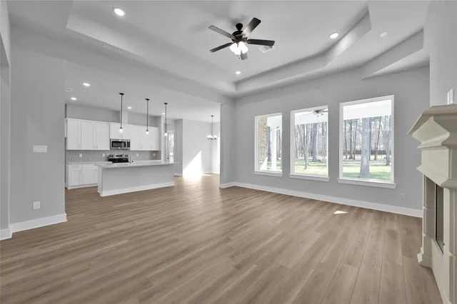 a view of large kitchen with a sink and wooden floor