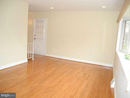323 Leyton Road Reisterstown, MD 21136 - Photo 3 of 29 an empty room with wooden floor and windows