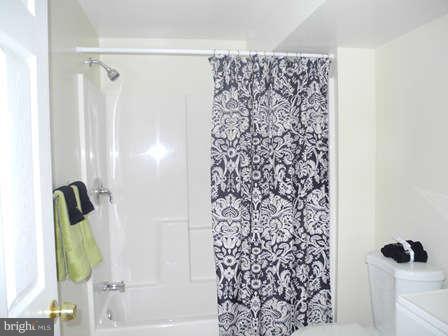 323 Leyton Road Reisterstown, MD 21136 - Photo 25 of 29 a bathroom with a shower curtain and a window