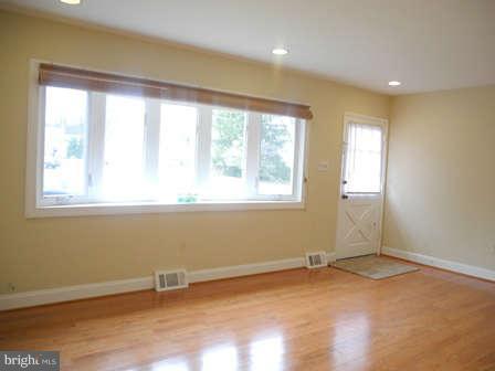 323 Leyton Road Reisterstown, MD 21136 - Photo 4 of 29 a view of an empty room with wooden floor and a window