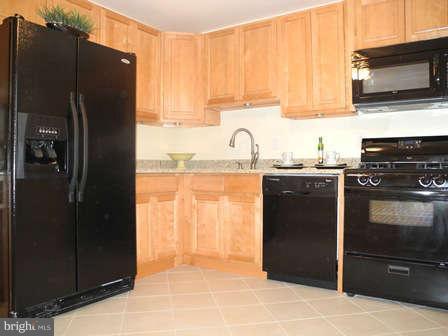 323 Leyton Road Reisterstown, MD 21136 - Photo 5 of 29 a kitchen with a refrigerator and a sink